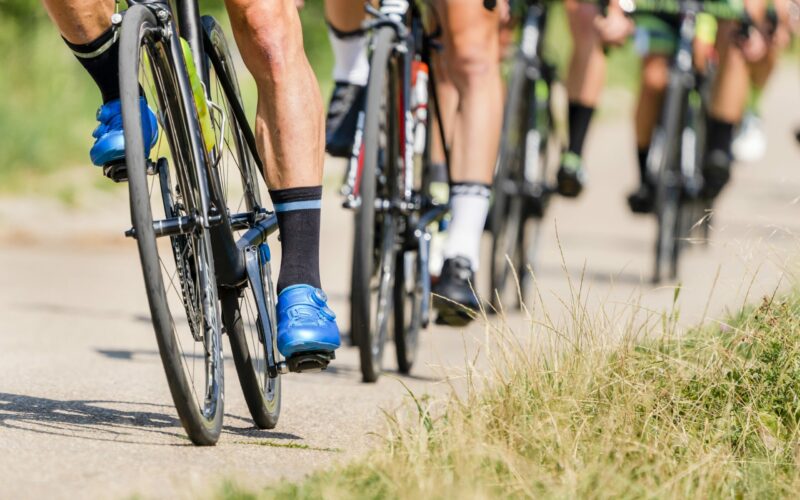 cyclist in a bycicle race detail of bike and feet of a cyclist in a bicycle race